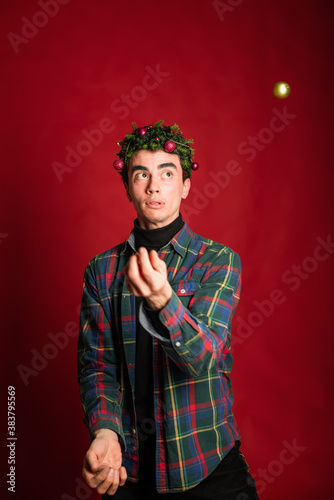 attractive man in a plaid shirt on a red background hair like a christmas tree christmas mood copyspace