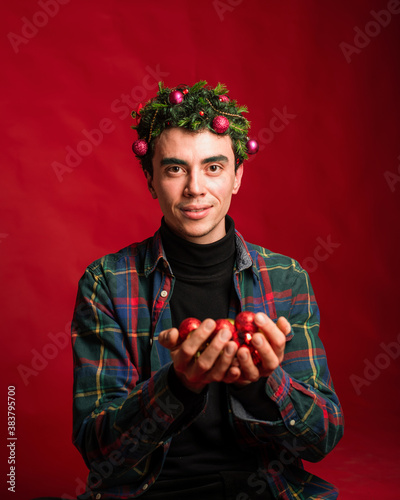 attractive man in a plaid shirt on a red background hair like a christmas tree christmas mood copyspace