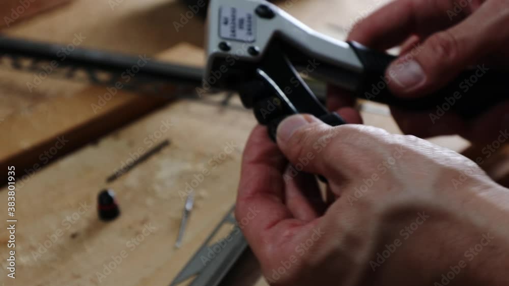Close up shot on hands of man using rivet plier to join aluminium profiles. Close up shot on hands of man using rivet plier to join aluminium profiles.