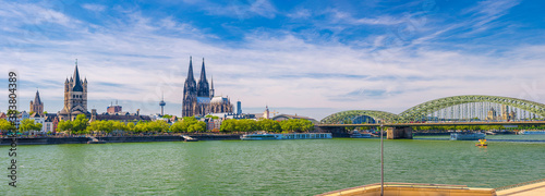 Fotografie Panorama of Cologne city historical centre with Cologne Cathedral of Saint Peter, Great Saint Martin Roman Catholic Church buildings and Hohenzollern Bridge across Rhine river