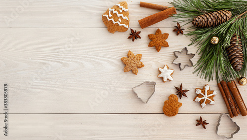 Christmas culinary background. Gingerbread on a white wooden background decorated with Christmas tree.