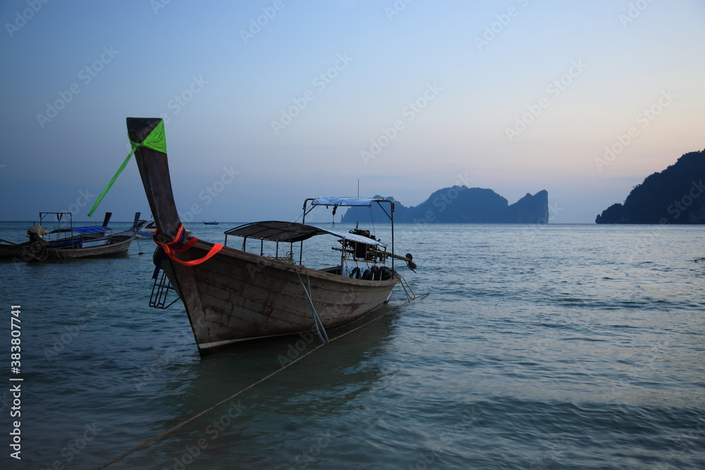View of Tonsai bay with longtail boats and  rocks during sunset in Phi Phi island,  Phuket, Krabi province , Thailand. 