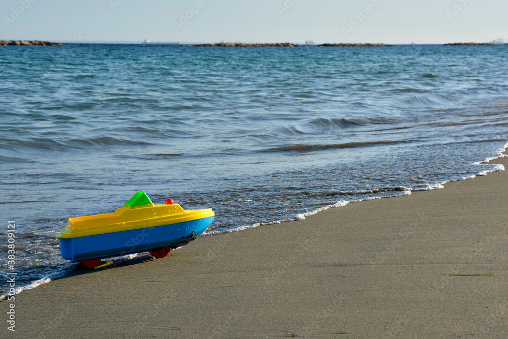 Toy Boat Parked on a Sandy Mediterranean Beach Toy Boat Parked on a Sandy Mediterranean Beach