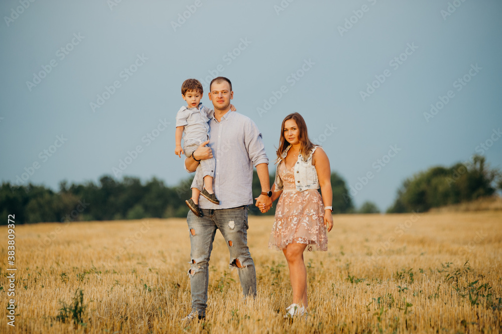 Happy family in the field evening light of a sun. Happy family in the field evening light of a sun.