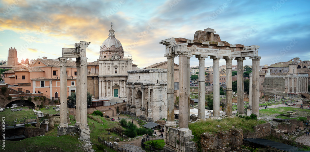 Panoramic view of Ruins of Roman Forum in Rome, Italy, also known as Foro di Cesare, or Forum of Caesar, on a bright summer day. on Capitolium hill in Roma at sunset. Panorama