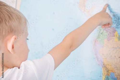 little boy on the background of a world map