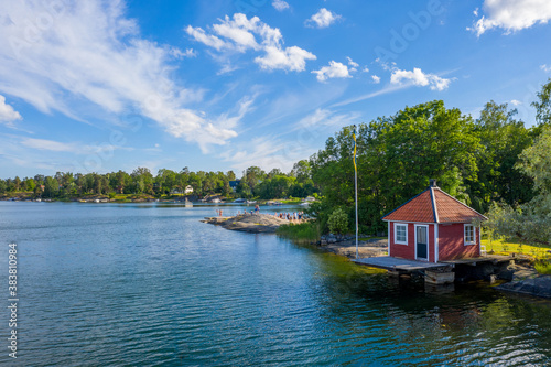 Photography Small red cottage by water in Stockholm archipelago in Sweden