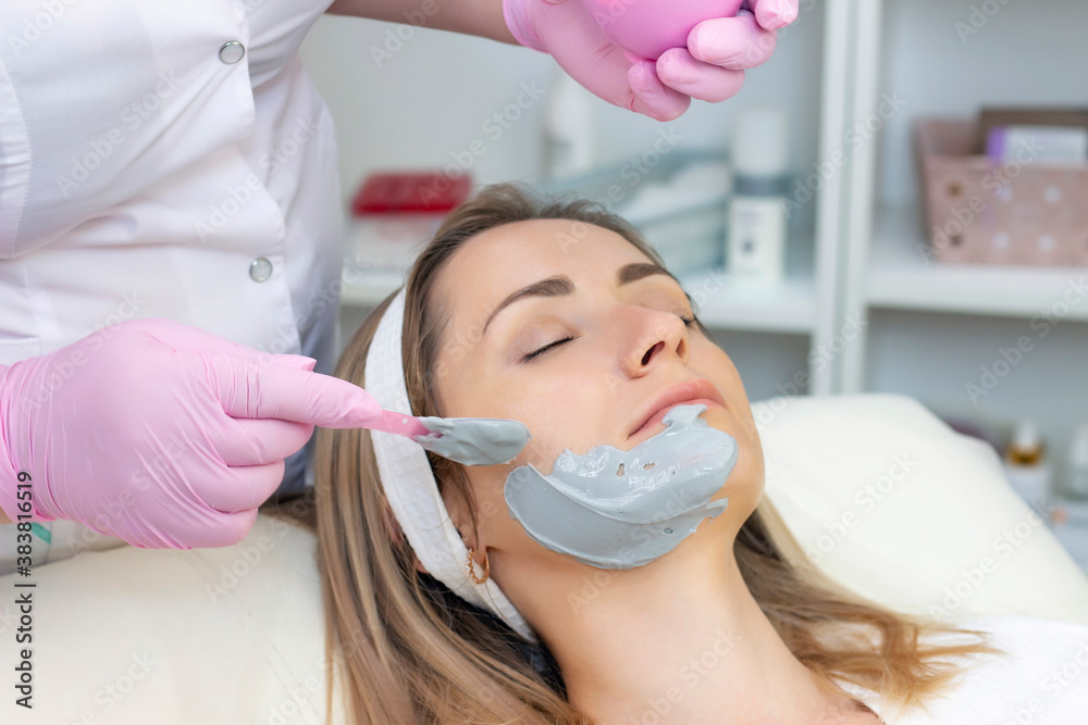 young woman is wearing a gray alginate mask. Cosmetic procedures young woman is wearing a gray alginate mask. Cosmetic procedures