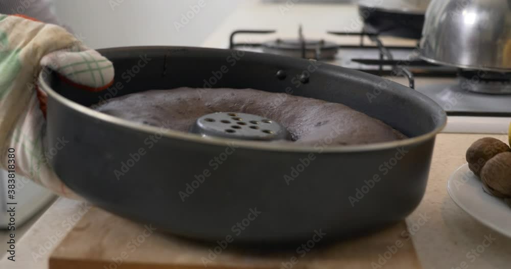 Housewife Cooking Baking Chocolate Cake in Gas Stove. Kitchen at Home. Blurred Shallow DOF Housewife Cooking Baking Chocolate Cake in Gas Stove. Kitchen at Home. Blurred Shallow DOF