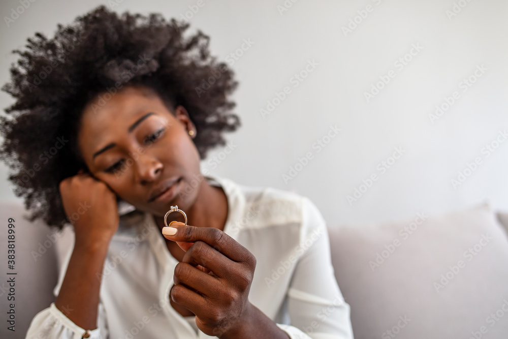 Upset depressed young woman holding wedding ring indoors, breaking off engagement, ending relationship, abandoned wife, cheated bride making hard decision, broken heart, breakup and divorce concept Upset depressed young woman holding wedding ring indoors, breaking off engagement, ending relationship, abandoned wife, cheated bride making hard decision, broken heart, breakup and divorce concept