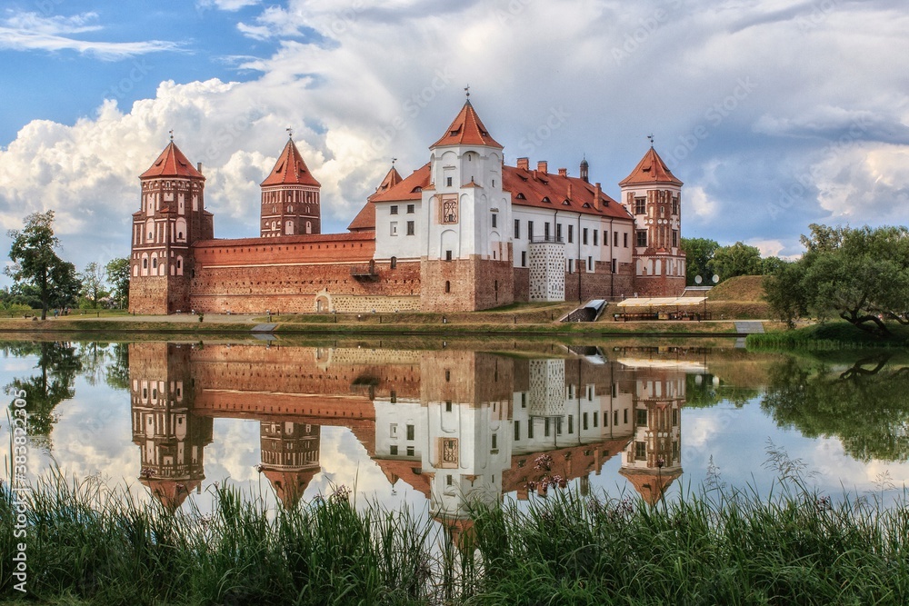 Castle with mirror reflection in the water of lake