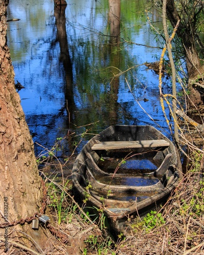 Landscape with river and old wooden boat