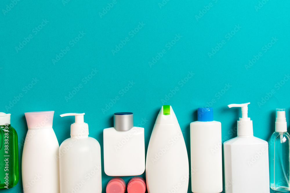 Top view of cosmetics bottles on colored background. Skin care concept with space for your design Top view of cosmetics bottles on colored background. Skin care concept with space for your design