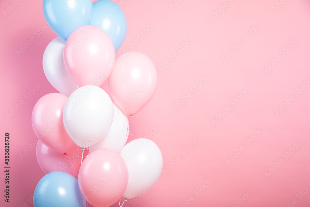 pink, white and blue balloon bundle on a bright pink backdrop 