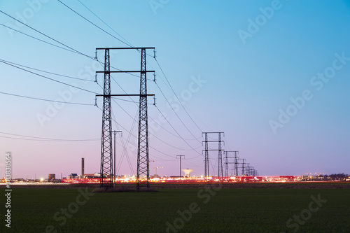 Silhouette of electricity pylon at sunset photo