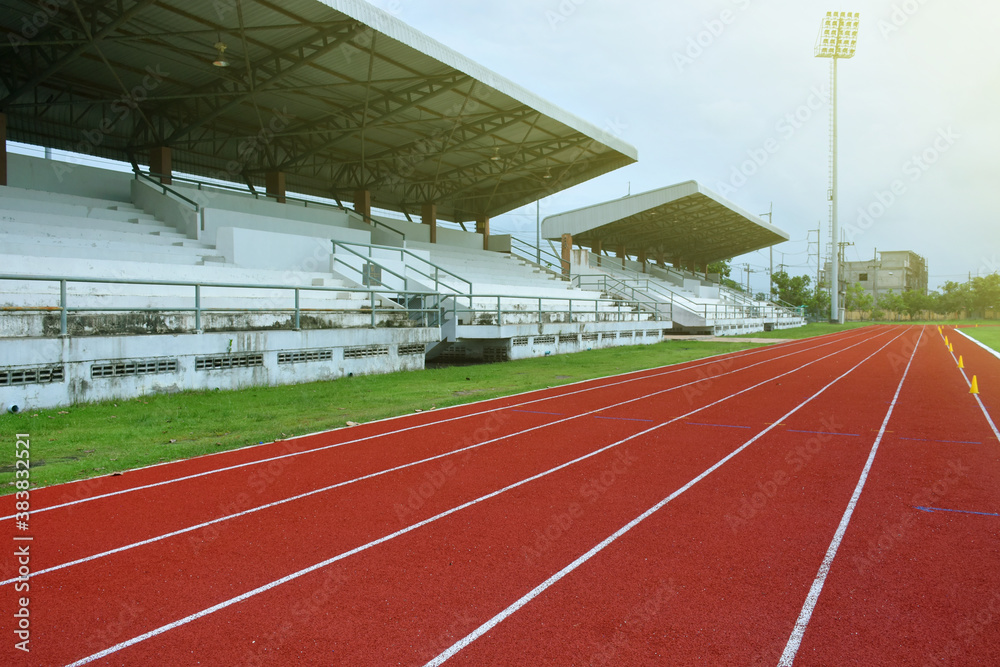 Empty athletic running track in sports stadium.