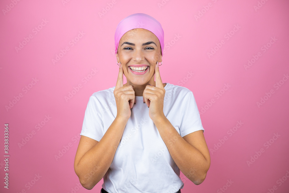 Young beautiful woman wearing pink headscarf over isolated pink background smiling confident showing and pointing with fingers teeth and mouth Young beautiful woman wearing pink headscarf over isolated pink background smiling confident showing and pointing with fingers teeth and mouth