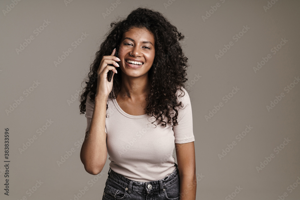 Smiling african woman talking on mobile phone Smiling african woman talking on mobile phone