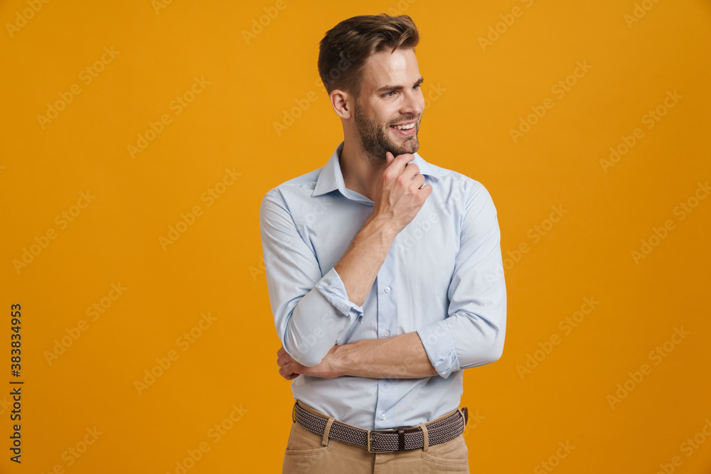Photo of joyful unshaven man smiling and looking aside Photo of joyful unshaven man smiling and looking aside
