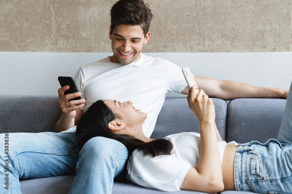 Happy cheery young loving couple at home Happy cheery young loving couple at home