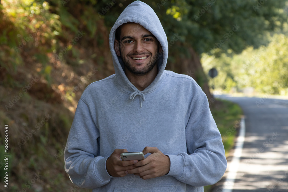 young man in sportswear and mobile phone young man in sportswear and mobile phone