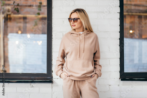 Young woman in glasses and hoodie