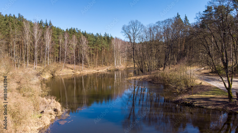The view from the top to the lake in the forest. Autumn. The view from the top to the lake in the forest. Autumn.