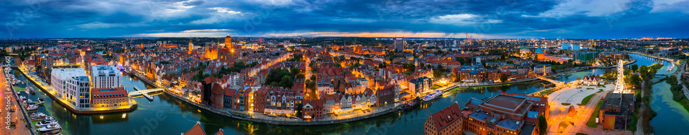 Aerial panorama of the Gdańsk city over Motława river with amazing architecture at dusk,  Poland