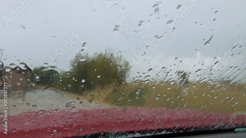 View from inside vehicle as hail sleet and rain hit the windshield  during storm in Wyoming.