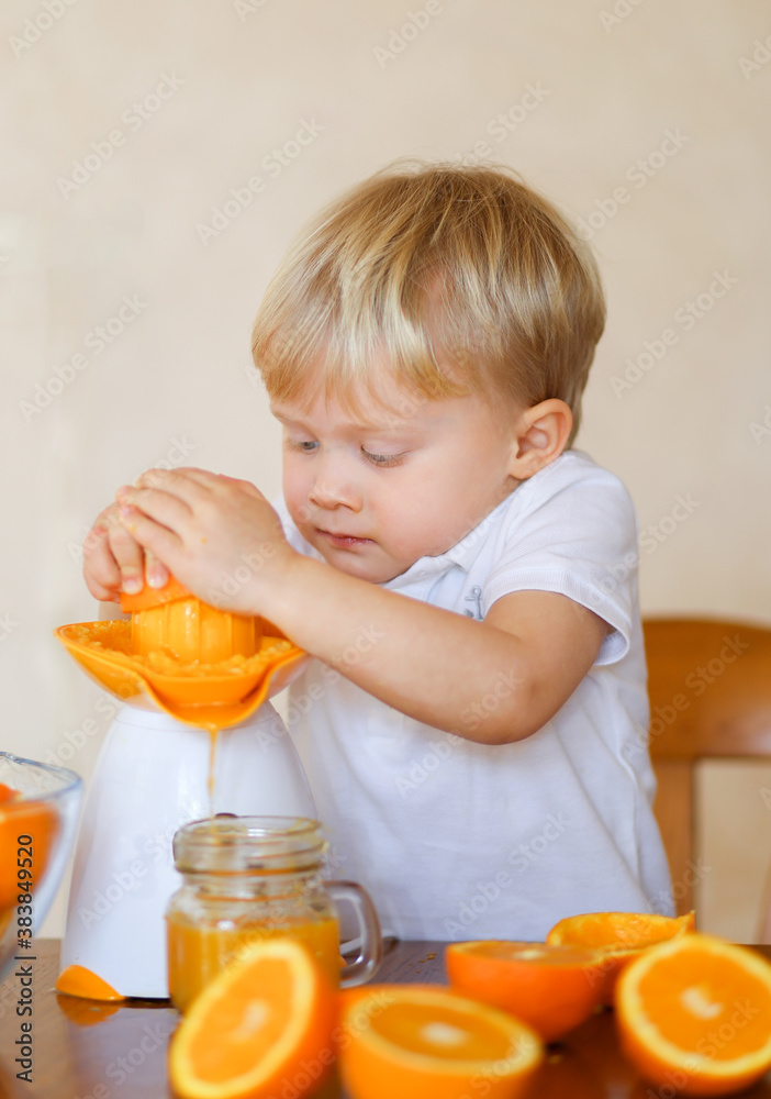3 years old boy making fresh orange juice 3 years old boy making fresh orange juice