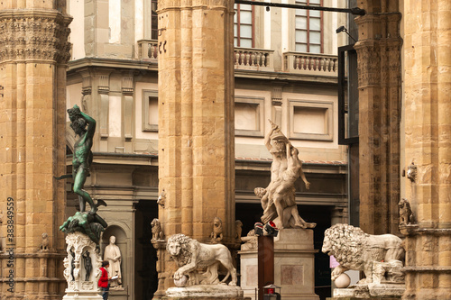 Sculpture of Loggia dei Lanzi and Florence Palazzo Vecchio on Piazza della Signoria in Florence, Italy. Architecture and landmark of Florence. photo