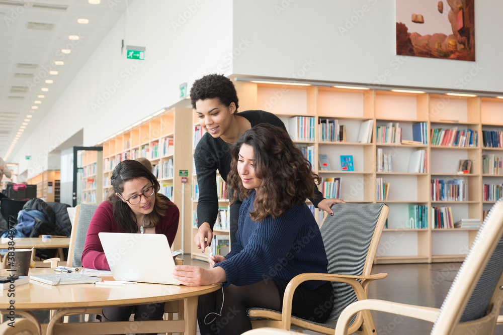 Women talking in library Women talking in library