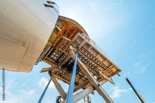 Canvas-taulu A Jumbo Jet freighter aircraft with a wide open nose cargo door being offloaded
