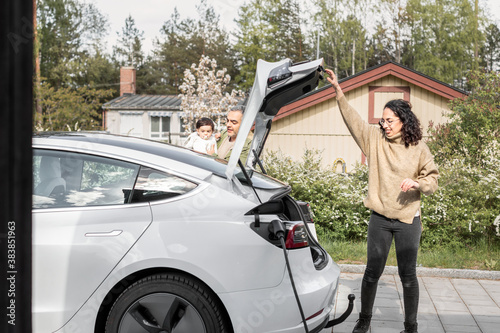 Woman closing car boot photo