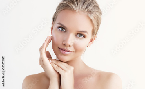 Beautiful young woman with clean fresh skin on face . Girl facial  treatment   . Cosmetology , beauty  and spa .
