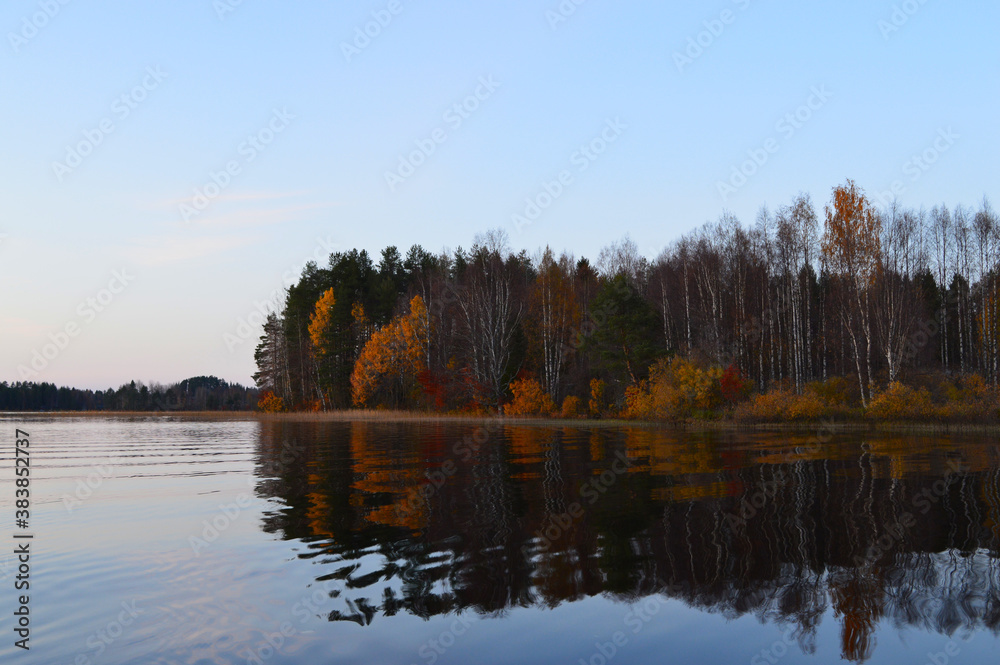 Autumn on the lake. Cool, clear water and little island with autumn colors.