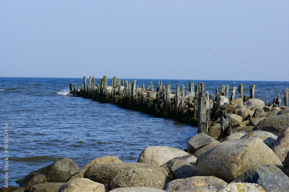 Travel photo of city Engure, Latvia. Baltic Sea with waves and mole Travel photo of city Engure, Latvia. Baltic Sea with waves and mole
