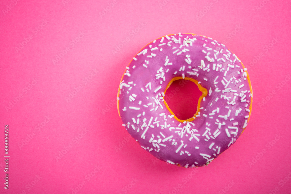 Studio shot of a colorful donut on pink background. Studio shot of a colorful donut on pink background.