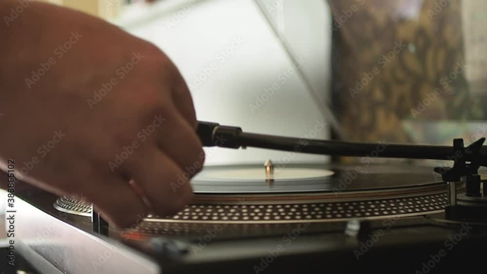 Close up of the stylus getting put onto the record. Men start playing vinyl record. Put the needle on the record. Selective focus.Static shot. Slow motion. Scene A. Close up of the stylus getting put onto the record. Men start playing vinyl record. Put the needle on the record. Selective focus.Static shot. Slow motion. Scene A.
