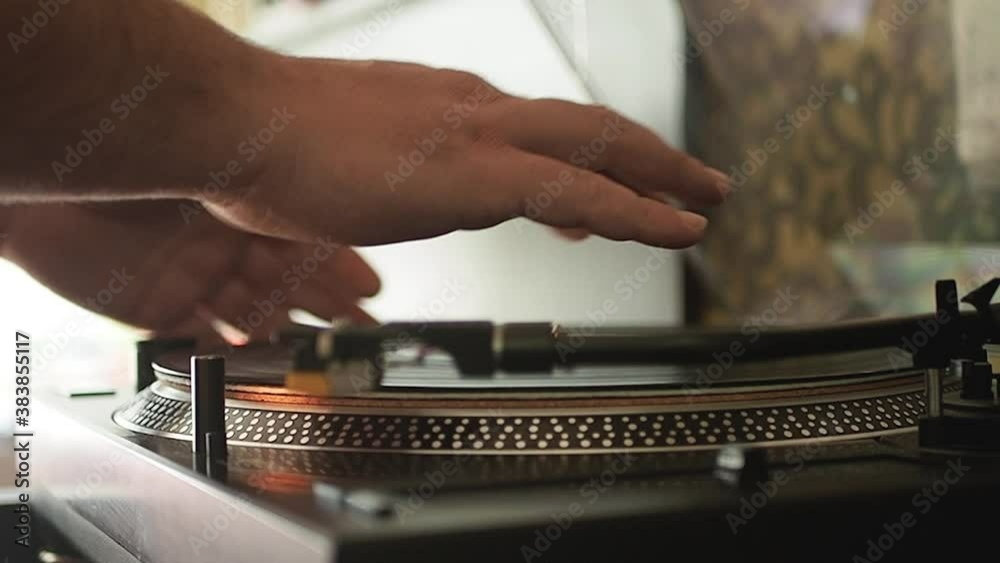 Close up of the stylus getting put onto the record. Men start playing vinyl record. Put the needle on the record. Selective focus.Static shot. Slow motion. Scene D.