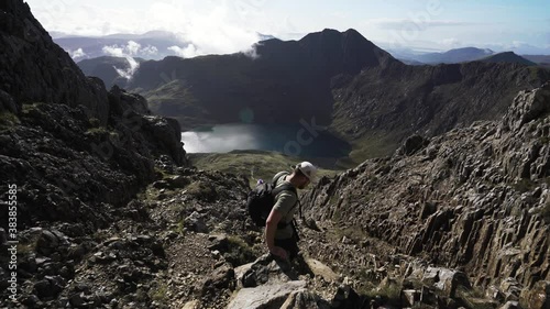 A man scrambling a Snowdonia National Park dangerous mountain 