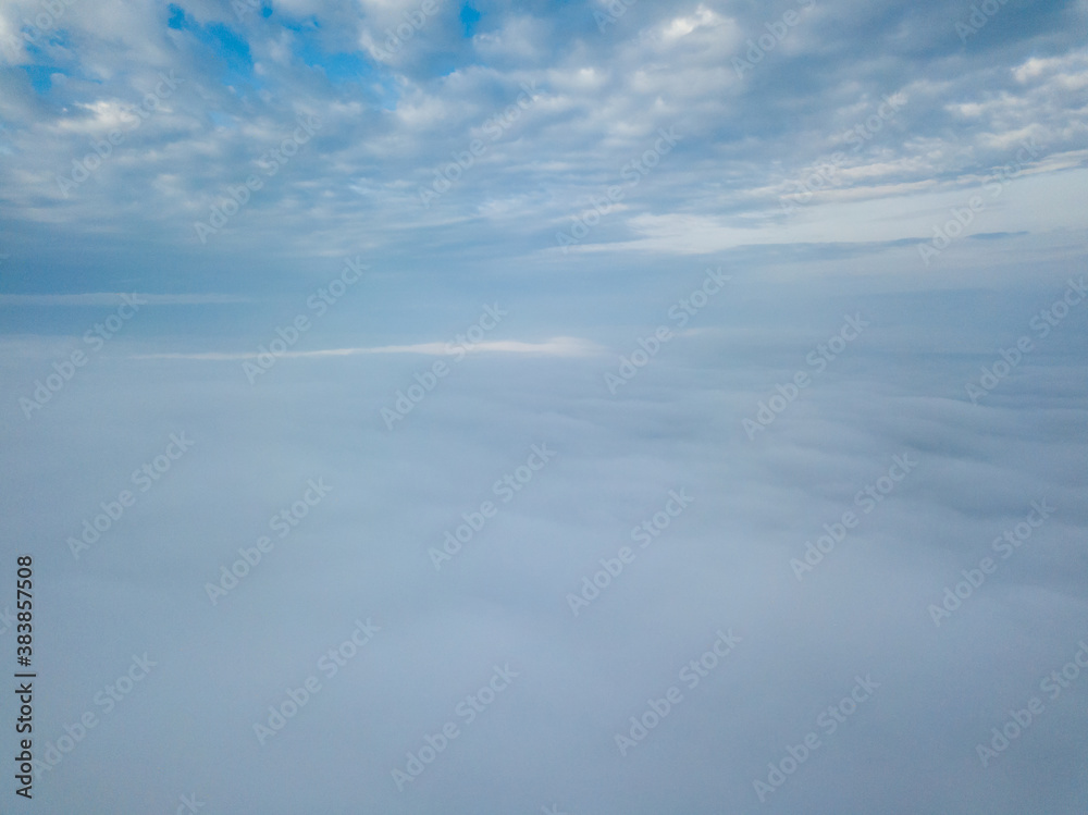 Aerial drone flight over the fog. There are thick clouds of fog below, cloudy. Aerial drone flight over the fog. There are thick clouds of fog below, cloudy.