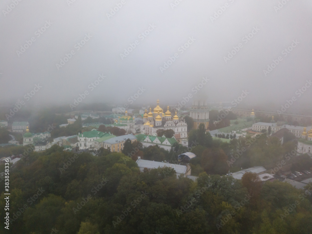 Aerial drone view. Kiev Pechersk Lavra in a dense fog.