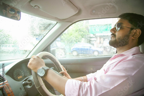 an Indian man driving a car