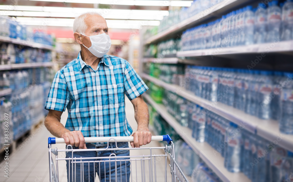 older european man wearing mask and gloves with covid protection shoping in supermarket older european man wearing mask and gloves with covid protection shoping in supermarket
