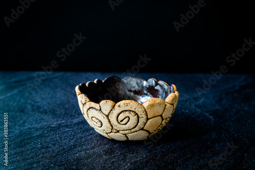 Handmade Ceramic Pottery Cup / Handcrafted Bowl on Dark Surface and Background.
