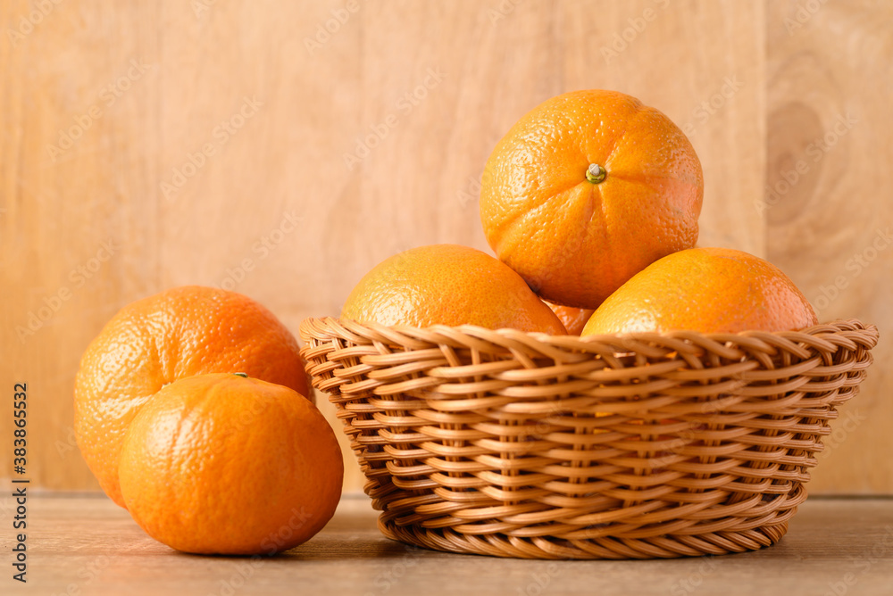 Fresh Honey Murcott orange fruit in basket on wooden background Fresh Honey Murcott orange fruit in basket on wooden background