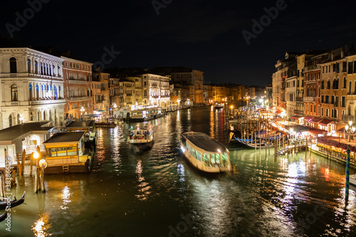 A nighttime view from the Rialto bridge, overlooking the Grand Canal 
