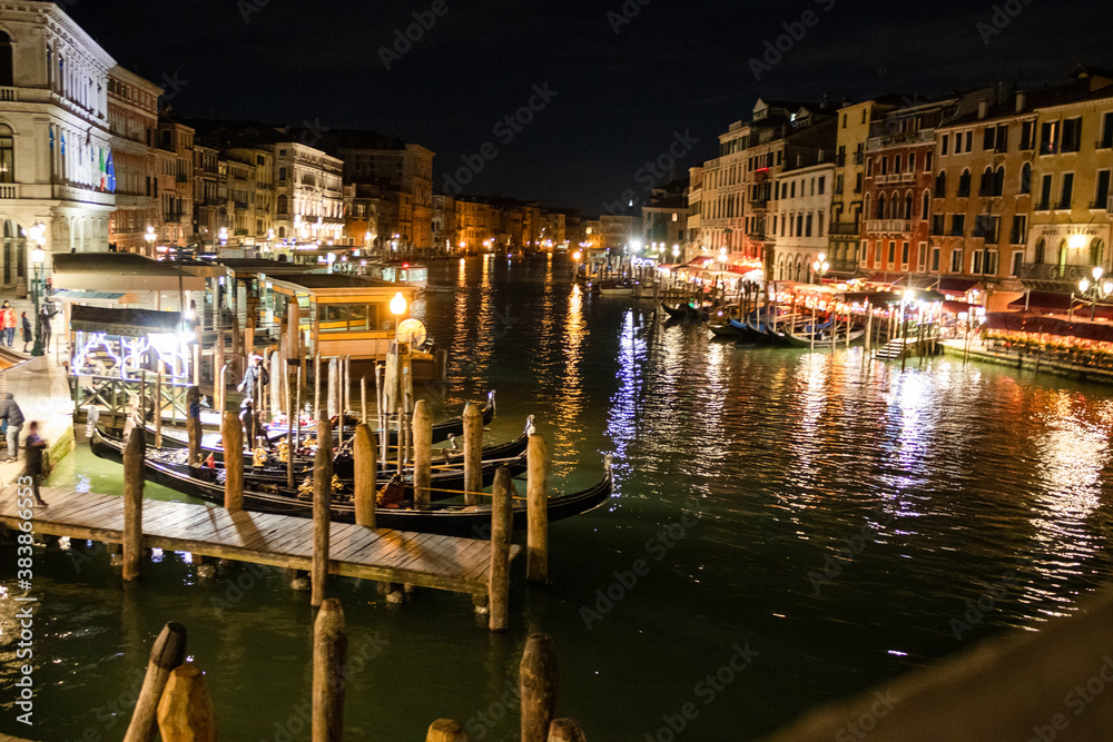 A nighttime view from the Rialto bridge, overlooking the Grand Canal 