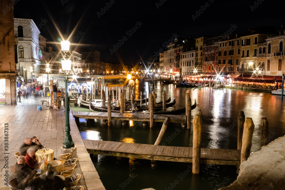 A nighttime view from the Rialto bridge, overlooking the Grand Canal 